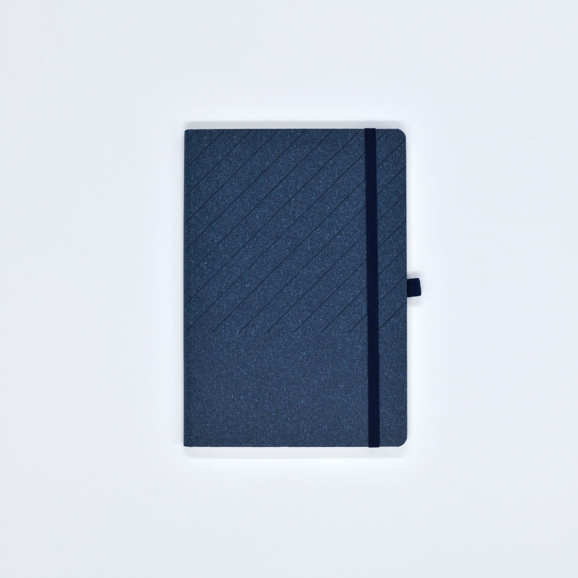 Blue notebook with a textured cover on a light gray background