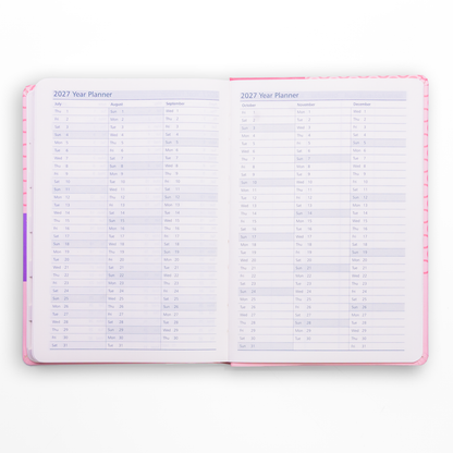 Open year planner with a pink cover on a white background