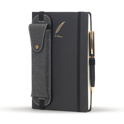 Black notebook with a pen holder and gold pen on a white background